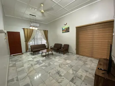 a living room with a couch and chairs and a table at Nur Kasih Homestay Seri Manjung in Seri Manjung