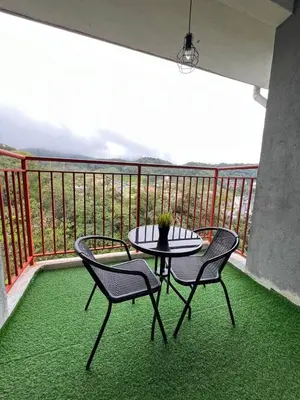 a patio with a table and two chairs on a balcony at Aufa Homestay at Emerald Avenue Brinchang in Brinchang