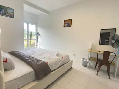 a white bedroom with a bed and a table at Aufa Homestay at Emerald Avenue Brinchang in Brinchang