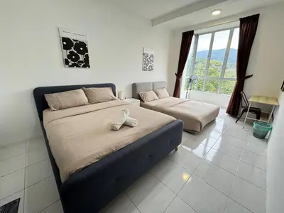 a bedroom with two beds in a room at Aufa Homestay at Emerald Avenue Brinchang in Brinchang