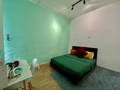 a room with a bed and a table and a desk at Cozy18#4pax#NearAeonAlma,Mcd#2kmtoIconic in Bukit Mertajam