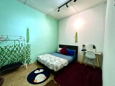 a bedroom with a bed and a table and a chair at Cozy18#4pax#NearAeonAlma,Mcd#2kmtoIconic in Bukit Mertajam