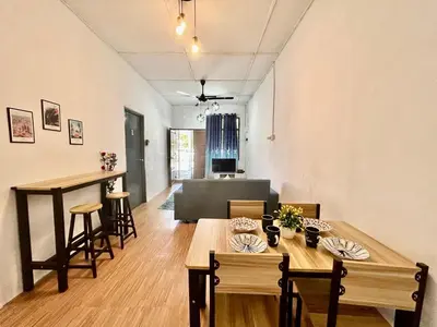 a living room with a table and chairs and a couch at Cozy18#4pax#NearAeonAlma,Mcd#2kmtoIconic in Bukit Mertajam