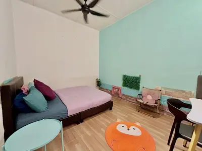 a bedroom with a bed and a table and chairs at Cozy16#4pax#wifi#NearAeonAlma#5kmtoiconcity in Bukit Mertajam