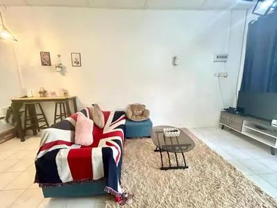 a living room with a couch and a teddy bear at Cozy16#4pax#wifi#NearAeonAlma#5kmtoiconcity in Bukit Mertajam