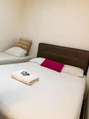 a bed with a towel on top of it at Tonight Hotel in George Town