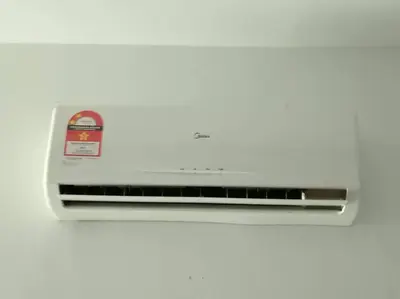 a toaster oven sitting on a white wall at Studio House Kampar in Kampar