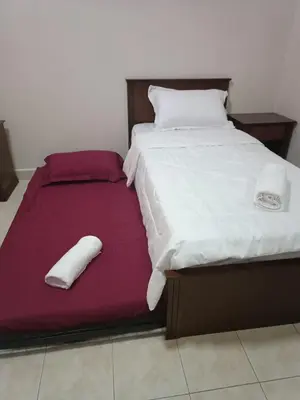 a bed with two white pillows on top of it at Sofea Inn Bukit Merah - Suria A7727 in Kampong Selemat
