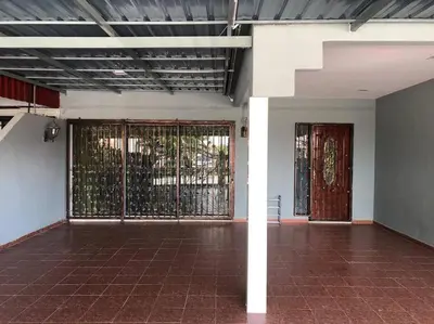 an empty room with two doors and a brick floor at One's Homestay in Seri Manjung