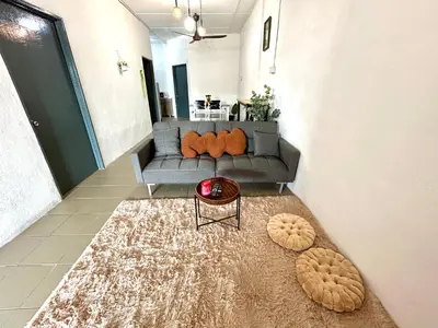 a living room with a couch and a table at Cozy33#4pax#Wifi#NearAeonAlma#20minstobatukawan in Bukit Mertajam