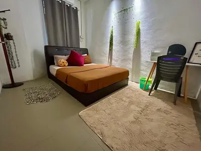 a bedroom with a bed and a table and a chair at Cozy33#4pax#Wifi#NearAeonAlma#20minstobatukawan in Bukit Mertajam