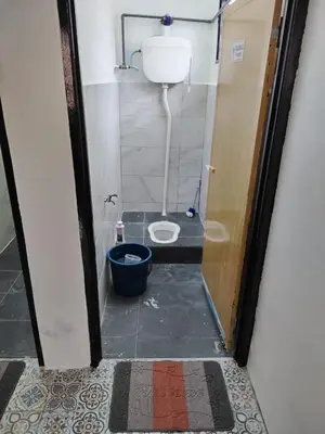 a small bathroom with a toilet in a stall at Homestay Embah Ros & Embah Lek in Hutan Melintang