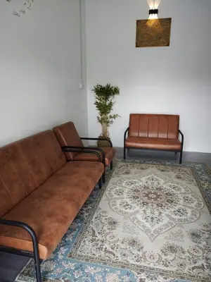 a living room with a couch and a rug at Homestay Embah Ros & Embah Lek in Hutan Melintang