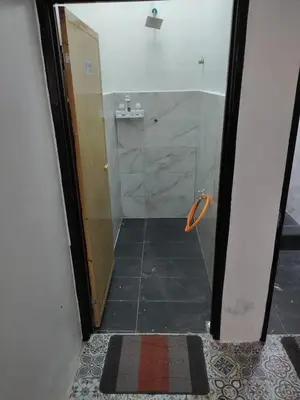 a bathroom with a shower with a glass door at Homestay Embah Ros & Embah Lek in Hutan Melintang