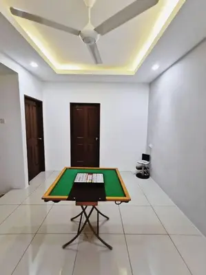 a ping pong table in the middle of a room at Botani Tmn Cyber Ipoh(24 pax /tv box/mahjong) in Ipoh