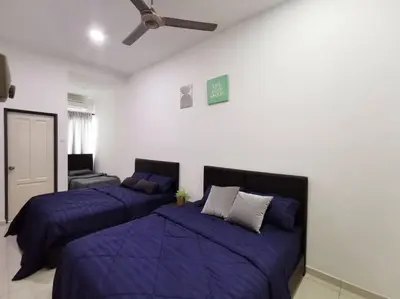 two beds in a white room with purple sheets at Bdr Seri Botani ipoh-nordic (tvbox/mahjong 19pax) in Ipoh