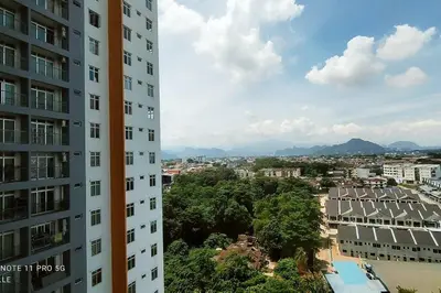 a view of a city from between two buildings at Spaces 3bed Room New Condo @ Kg Paloh Ipoh in Ipoh