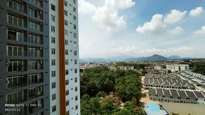 a view of a city from between two buildings at Spaces 3bed Room New Condo @ Kg Paloh Ipoh in Ipoh