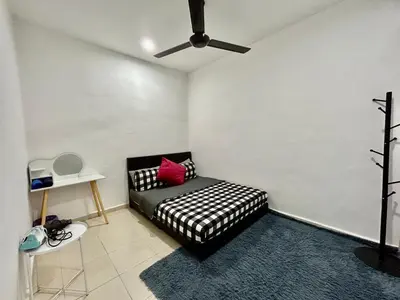 a black and white couch in a room with a ceiling fan at Cozy288#4pax#wifi#NearAeonAlma,Mcd#2kmtoIconicPoint in Bukit Mertajam