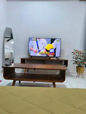 a television sitting on top of a wooden entertainment center at The Sun 1 or 3BR Bayan Lepas 4 to 10 pax WL in Bayan Lepas