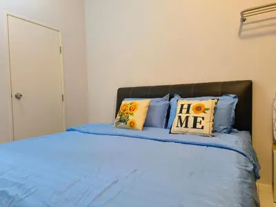 a bedroom with a bed with blue sheets and pillows at The Sun 1 or 3BR Bayan Lepas 4 to 10 pax WL in Bayan Lepas