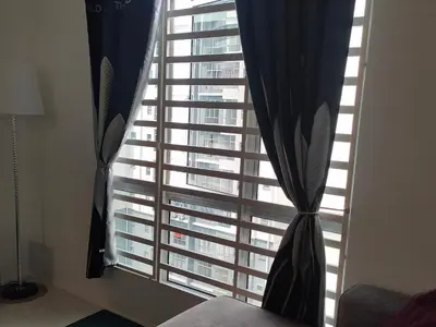 a bedroom with a large window with blue curtains at Homestay Millazzz Apparment Ipoh in Kampong Duson Gilap