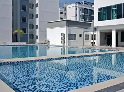 a large swimming pool in the middle of a building at Homestay Millazzz Apparment Ipoh in Kampong Duson Gilap