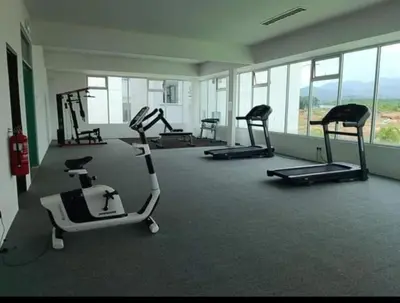 a gym with several exercise bikes in a room at Homestay Millazzz Apparment Ipoh in Kampong Duson Gilap