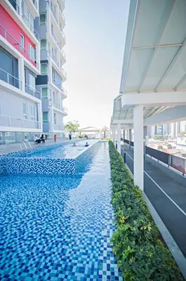 a building with a swimming pool with blue tiles on it at PoP Kitty Octagon Premium Ipoh Town Center 2BR by Grab A Stay in Ipoh