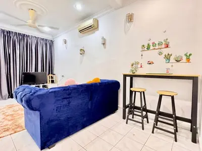 a living room with a blue couch and a table at Cozy14#4pax#Wifi#NearAeonAlma#5kmtoIconCity in Bukit Mertajam