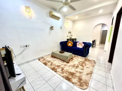 a living room with a blue couch and a rug at Cozy14#4pax#Wifi#NearAeonAlma#5kmtoIconCity in Bukit Mertajam