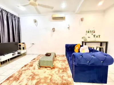 a living room with a blue couch and a table at Cozy14#4pax#Wifi#NearAeonAlma#5kmtoIconCity in Bukit Mertajam