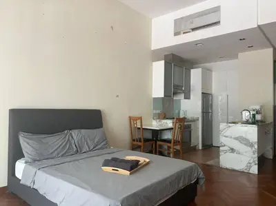 a bedroom with a bed with a tray on it at Perfect Marina Stay @ Strait Quay 6 Pax Max in Bagan Jermal