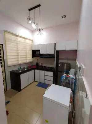 a kitchen with white cabinets and a white refrigerator at KS Villa Homestay Kuala Kubu Bharu in Kampong Peruntun
