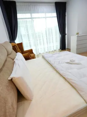 a bedroom with a large bed and a large window at Ipoh Lake View Cozy Home Big House in Lahat