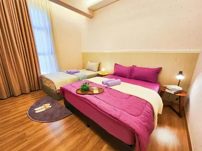 two beds in a room with pink sheets at The Cove Ipoh Garden East, Taman Ipoh Permai, Garden East, 31400 IPOH in Ipoh