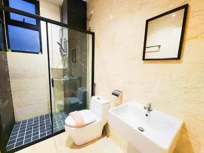 a bathroom with a toilet and a sink and a shower at The Cove Ipoh Garden East, Taman Ipoh Permai, Garden East, 31400 IPOH in Ipoh