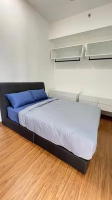 a bedroom with a bed and white walls and wooden floors at Beacon Executive Suites #Georgetown #RoofTopPool #10 in George Town