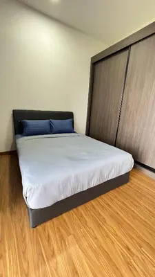 a large bed in a room with a wooden floor at Beacon Executive Suites #Georgetown #RoofTopPool #10 in George Town
