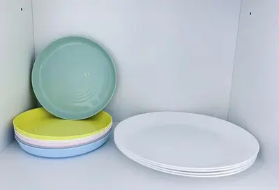 a stack of plates sitting next to a mirror at Beacon Executive Suites #Georgetown #RoofTopPool #10 in George Town