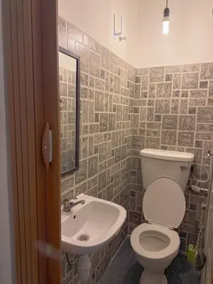 a bathroom with a toilet and a sink at G99 Hotel in George Town