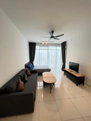a living room with a black couch and a tv at Beacon Executive Suites #CozyFamilyStay #RoofTopPool #16 #10paxs in George Town