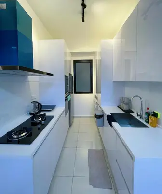 a white kitchen with white counters and a sink at Beacon Executive Suites #CozyFamilyStay #RoofTopPool #16 #10paxs in George Town