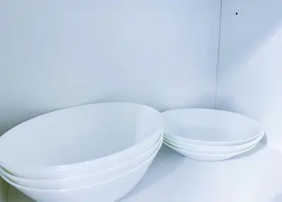 two white bowls are sitting on a shelf at Beacon Executive Suites #CozyFamilyStay #RoofTopPool #16 #10paxs in George Town