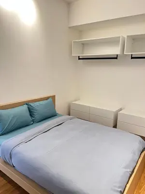 a bedroom with a large bed with blue pillows at Beacon Executive Suites #CozyFamilyStay #RoofTopPool #16 #10paxs in George Town