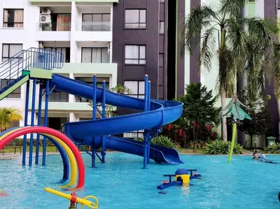 a blue slide in a swimming pool in a resort at Ipoh Manhattan waterpark safari-12pax(projector) in Ipoh