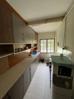 a large kitchen with a counter in a room at De Cameron Guest House in Tanah Rata