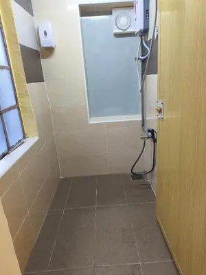 a bathroom with a shower with a window and a door at De Cameron Guest House in Tanah Rata