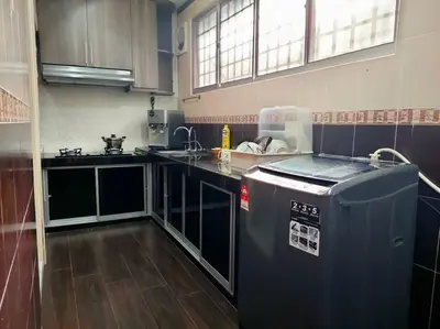 a kitchen with a counter and a dishwasher in it at 678 homestay 4 room 5 minutes to tower in Teluk Intan