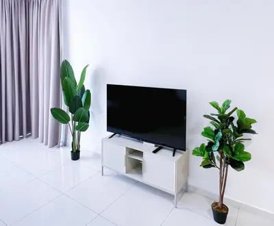 a flat screen tv sitting on a white stand in a living room at Beacon Executive Suites #Georgetown #RoofTopPool #23A in George Town